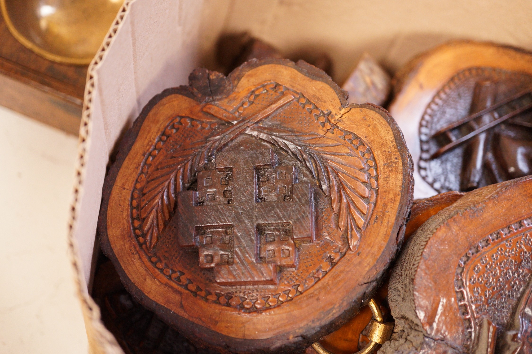 A collection of Jerusalem carved oyster olive wood roundels, religious and other symbolism